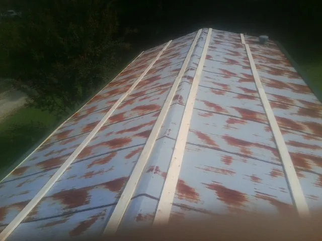 Rusted metal roof panels with new wood purlins before replacement — Storm Damage Roof Repair in Woodruff by Roofing Brothers